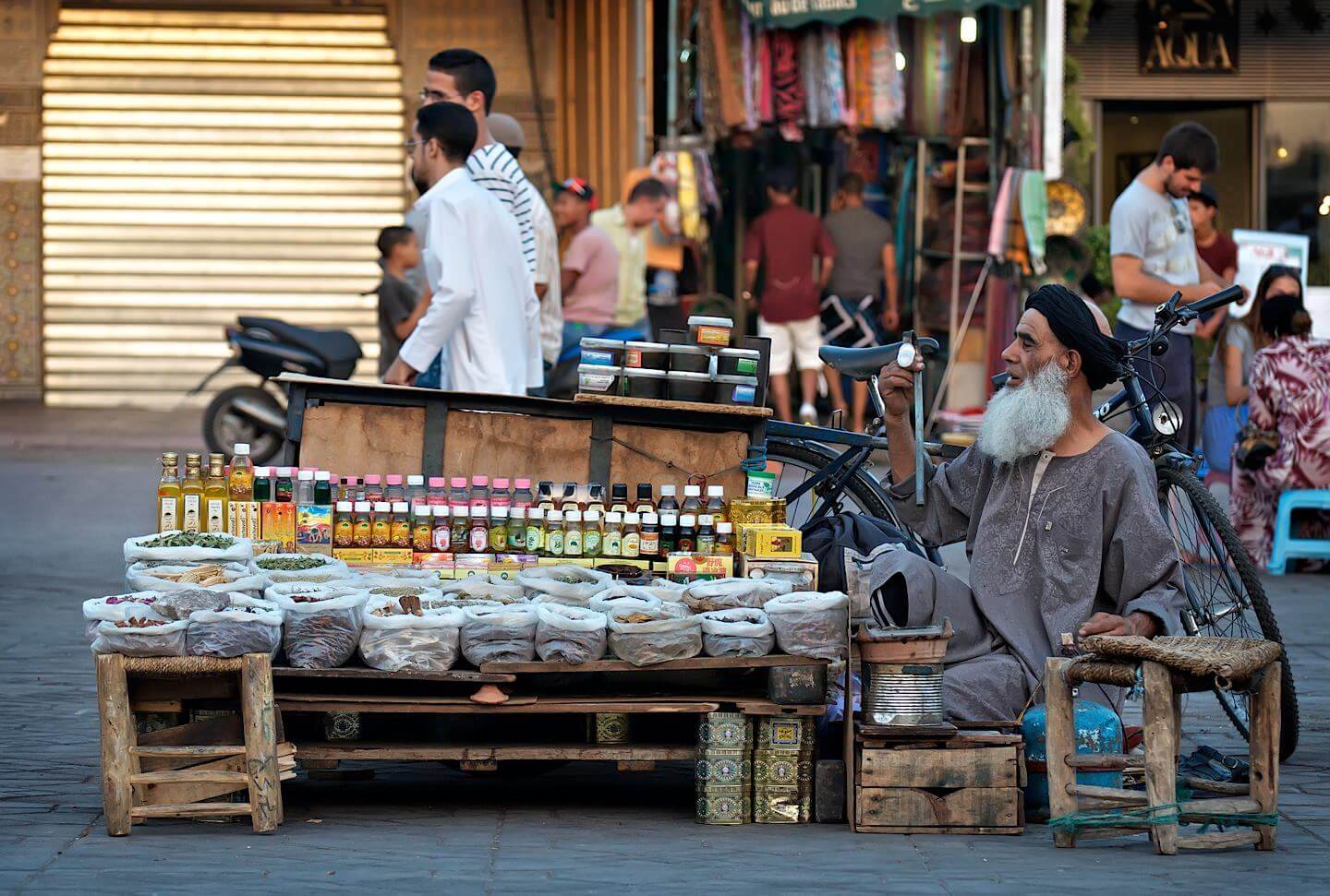 Starý muž s plnovousem prodává věci na ulici; Marrákeš